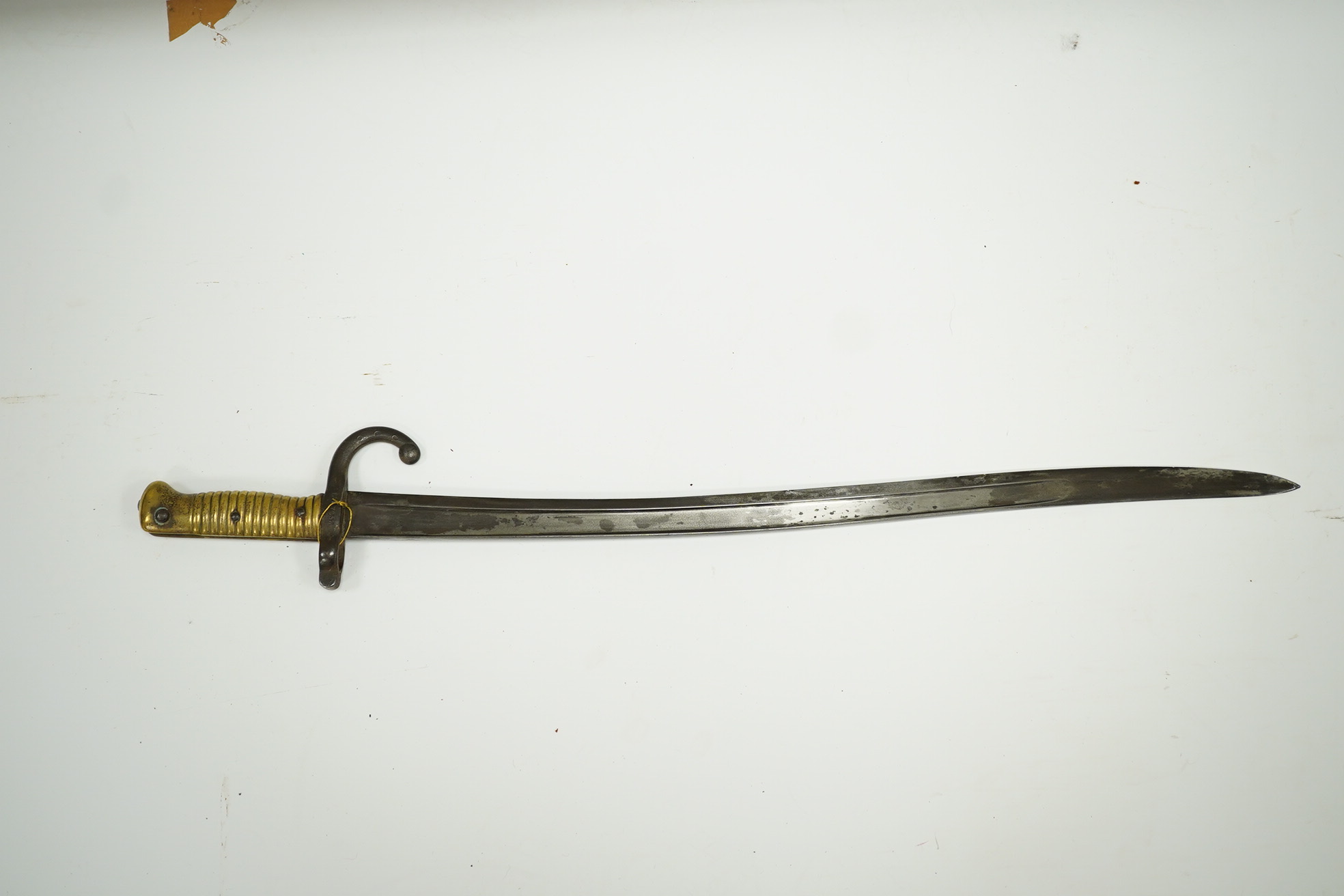 A French bayonet for a chassepot rifle, regulation blade dated 1871 and regulation hilt, in its iron scabbard. Condition - fair